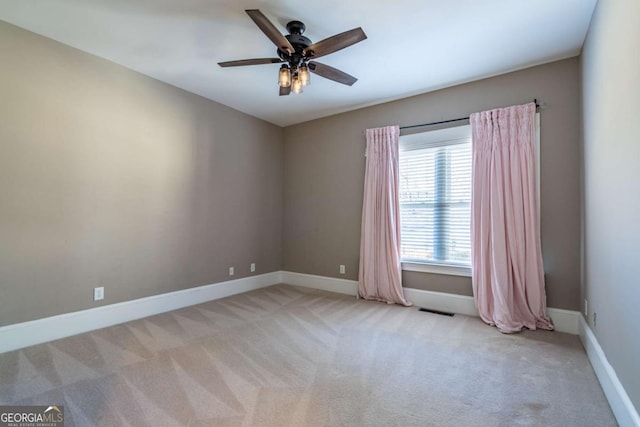 spare room with light carpet and ceiling fan