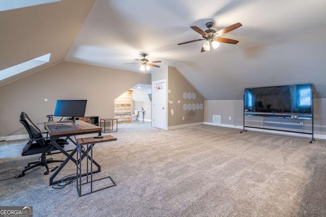 home office with vaulted ceiling, ceiling fan, and carpet floors