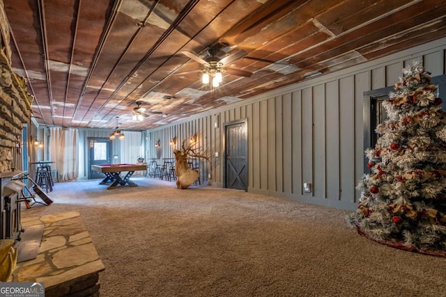 basement with carpet, ceiling fan, and pool table