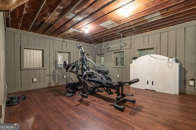 exercise room with hardwood / wood-style floors and wood ceiling