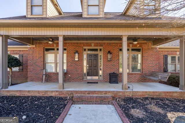 view of exterior entry featuring ceiling fan and a porch