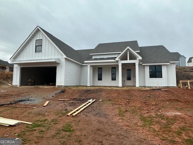 view of front facade with a garage and covered porch