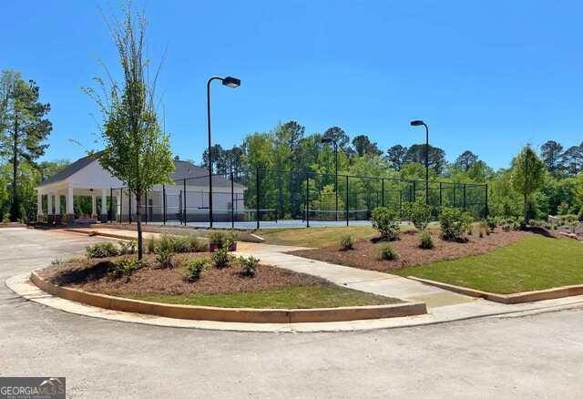 view of community featuring tennis court