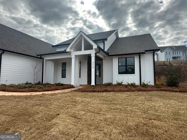 view of front of home with a front lawn and board and batten siding