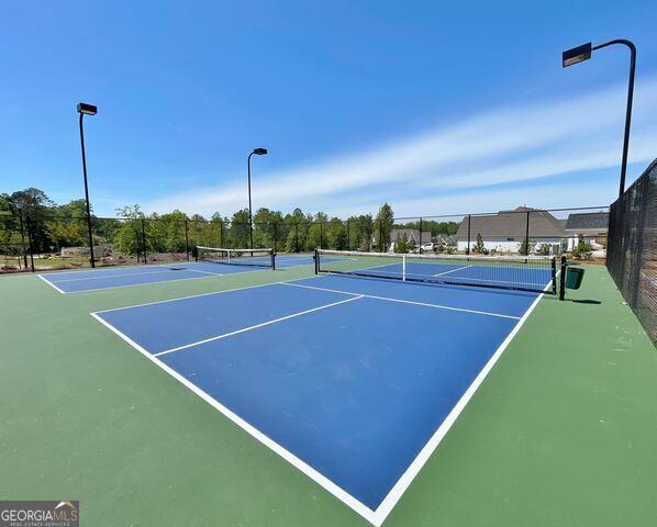 view of sport court with basketball hoop