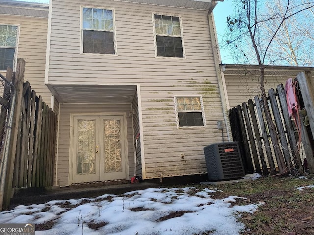 snow covered rear of property with central AC