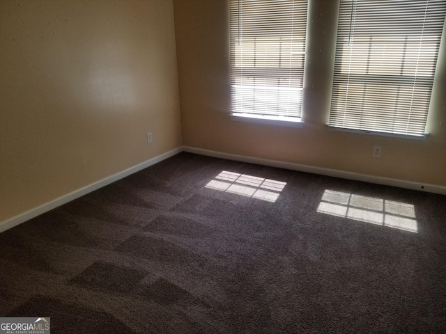 2590 Wellington Walk Pl, Lithonia, GA 30058 - unfurnished room featuring dark colored carpet and baseboards