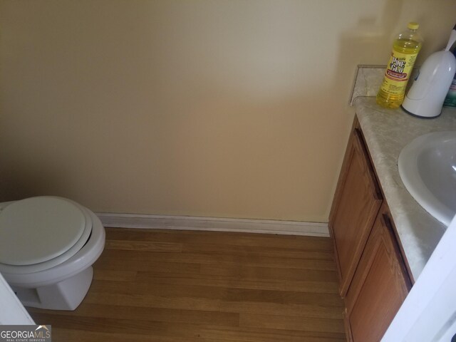 2590 Wellington Walk Pl, Lithonia, GA 30058 - bathroom featuring wood finished floors, baseboards, and vanity