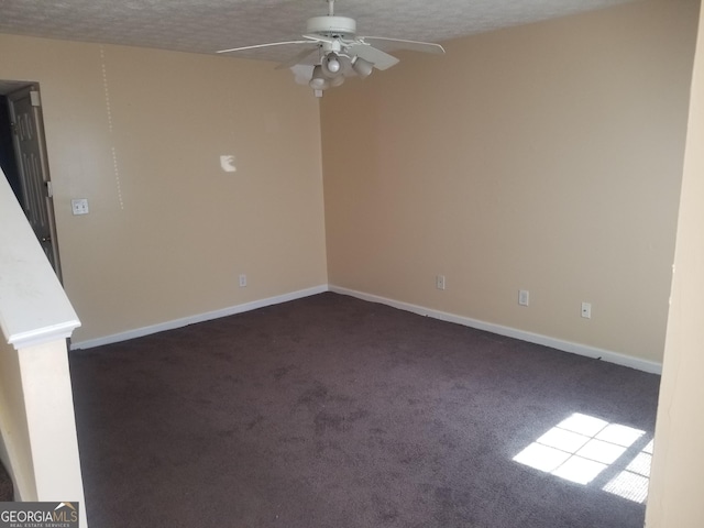 carpeted empty room featuring ceiling fan and a textured ceiling