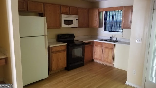 2590 Wellington Walk Pl, Lithonia, GA 30058 - kitchen featuring white appliances, a sink, light wood-style flooring, light countertops, and brown cabinets