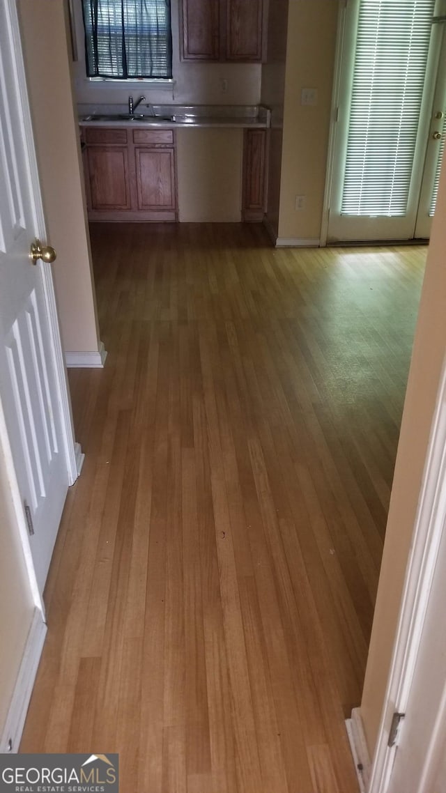 2590 Wellington Walk Pl, Lithonia, GA 30058 - unfurnished dining area with light wood-style flooring and a sink