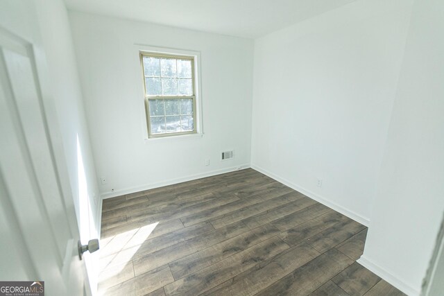 spare room featuring dark hardwood / wood-style floors