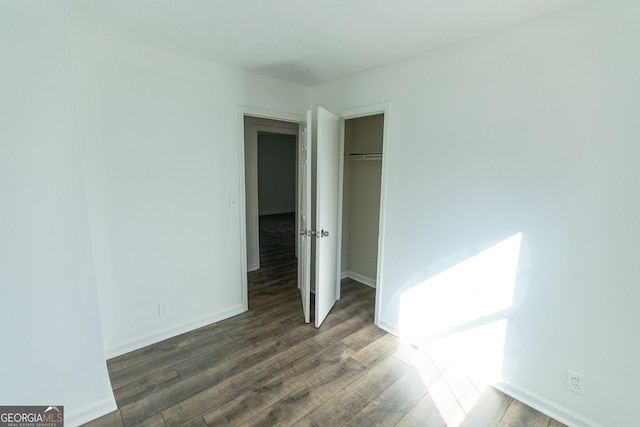 unfurnished bedroom featuring dark hardwood / wood-style floors