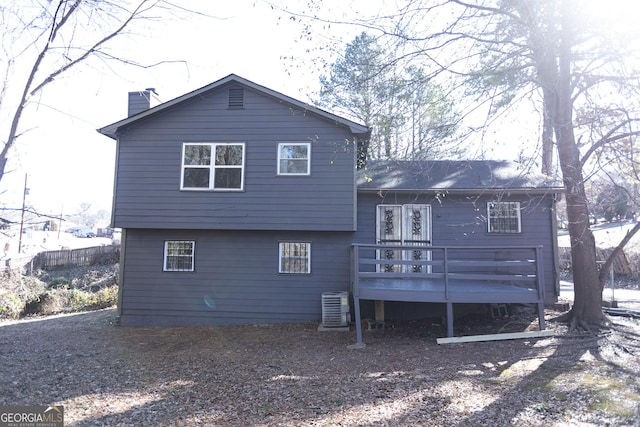 rear view of property featuring a deck and central air condition unit