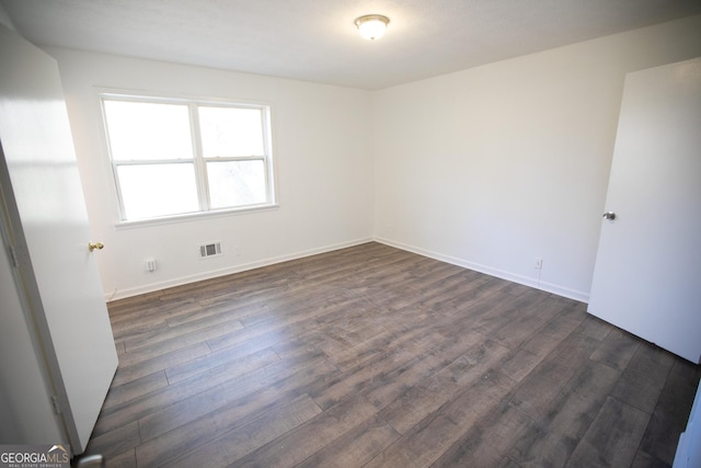 empty room with dark hardwood / wood-style floors