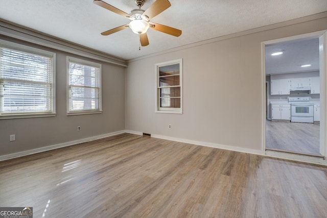 unfurnished room with a textured ceiling, ceiling fan, ornamental molding, and light hardwood / wood-style flooring