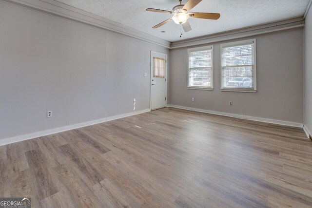 spare room featuring ceiling fan, ornamental molding, a textured ceiling, and light hardwood / wood-style floors