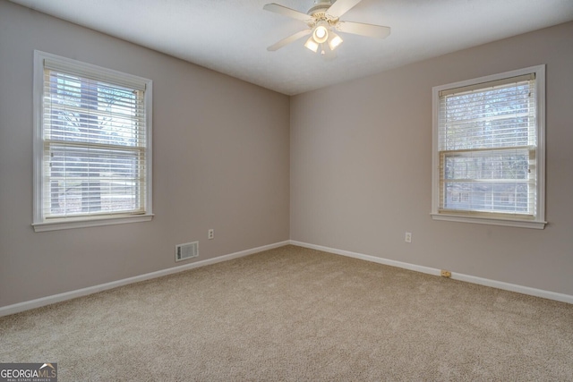 unfurnished room with light carpet and ceiling fan