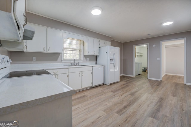 kitchen featuring white appliances, white cabinets, washer / dryer, light hardwood / wood-style floors, and sink