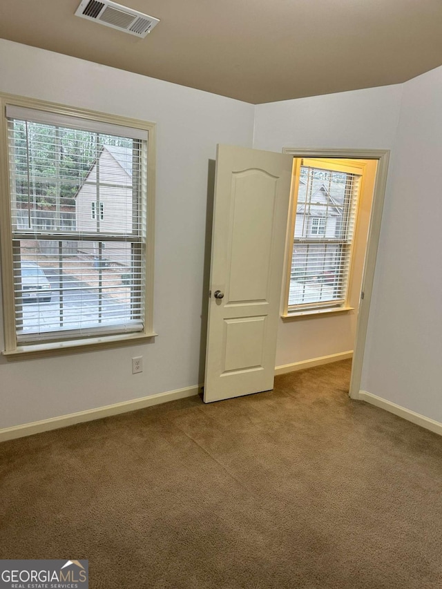 spare room featuring carpet floors