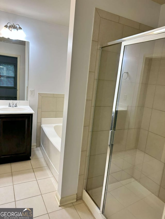 bathroom with tile patterned floors, separate shower and tub, and vanity