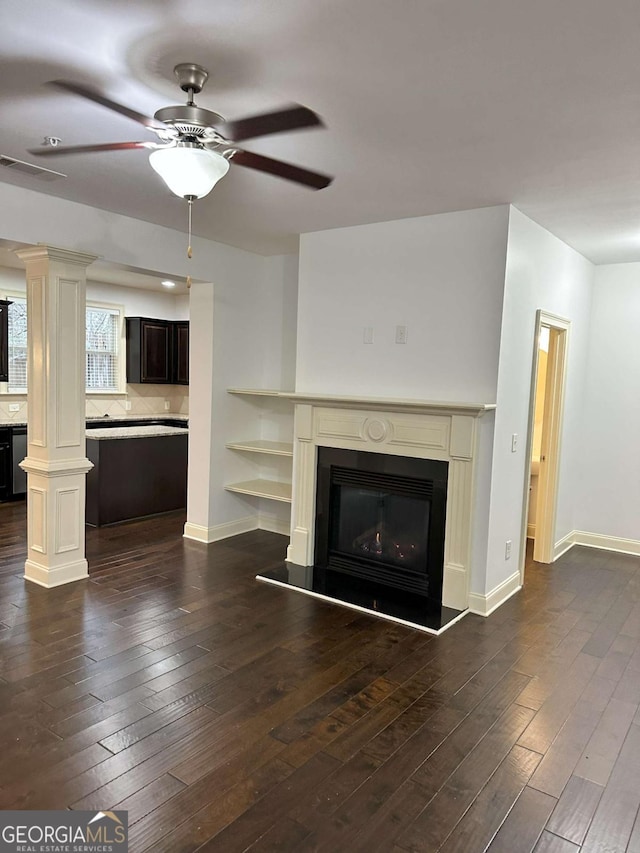 unfurnished living room with ceiling fan and dark wood-type flooring