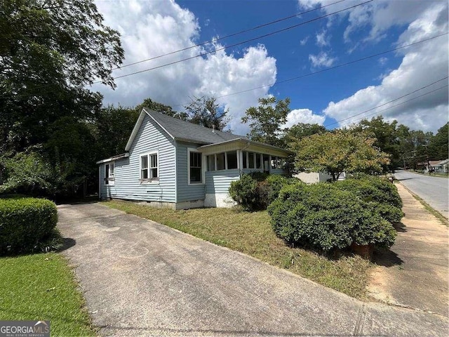 view of side of home with a yard