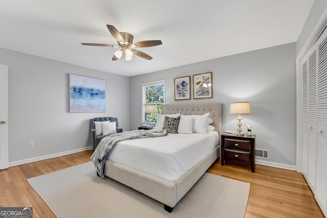 bedroom featuring wood-type flooring, a closet, and ceiling fan