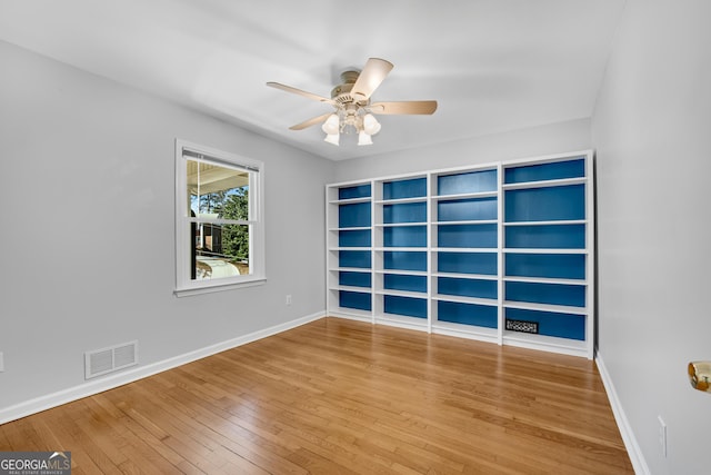 empty room with wood-type flooring and ceiling fan