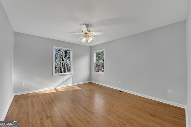 spare room featuring ceiling fan and light hardwood / wood-style flooring