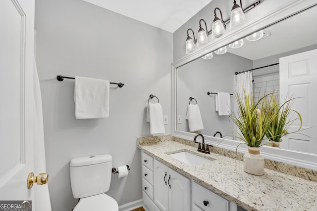 bathroom with vanity, toilet, and a shower with shower curtain