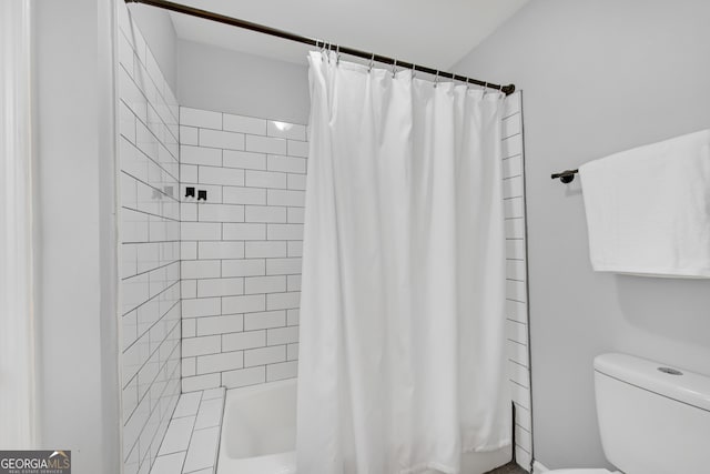 bathroom with shower / bath combination with curtain and toilet