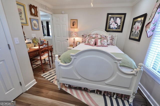 bedroom featuring crown molding and hardwood / wood-style flooring