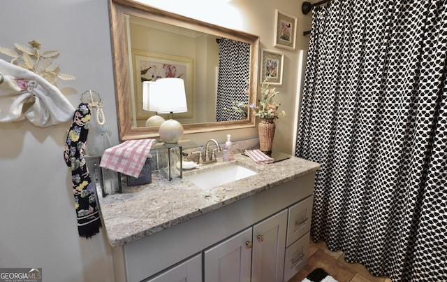 bathroom with tile patterned floors and vanity