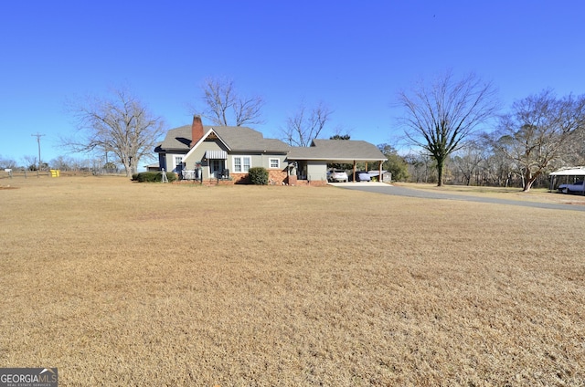 view of front facade featuring a front lawn and a carport