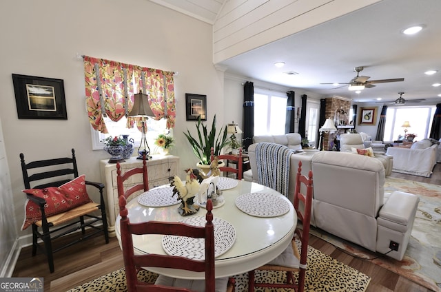 dining room featuring hardwood / wood-style flooring, lofted ceiling, and ceiling fan