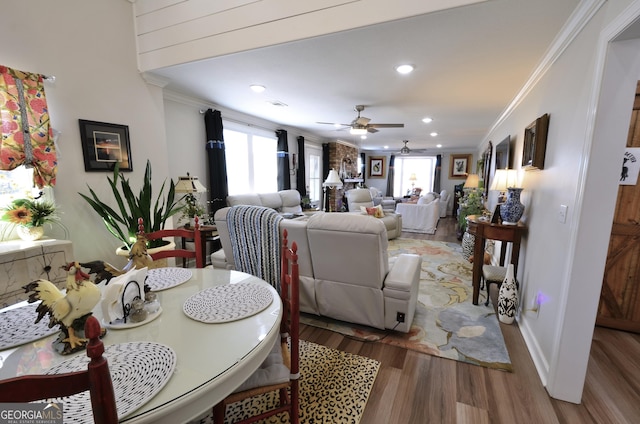 dining room with ceiling fan, hardwood / wood-style flooring, and crown molding