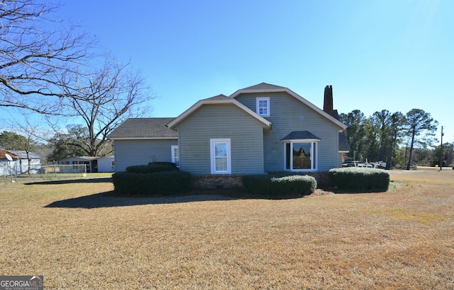 view of side of home with a lawn