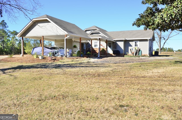 view of front facade with a front yard and a carport