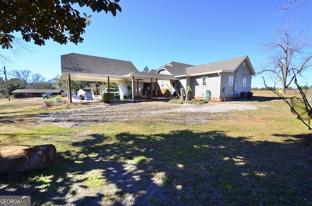 back of house with a lawn