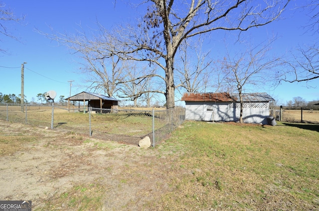 view of yard featuring a rural view and an outdoor structure