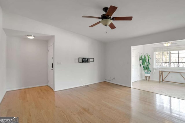 unfurnished room with ceiling fan and light hardwood / wood-style floors