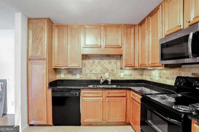 kitchen with tasteful backsplash, light tile patterned flooring, dark stone countertops, black appliances, and sink