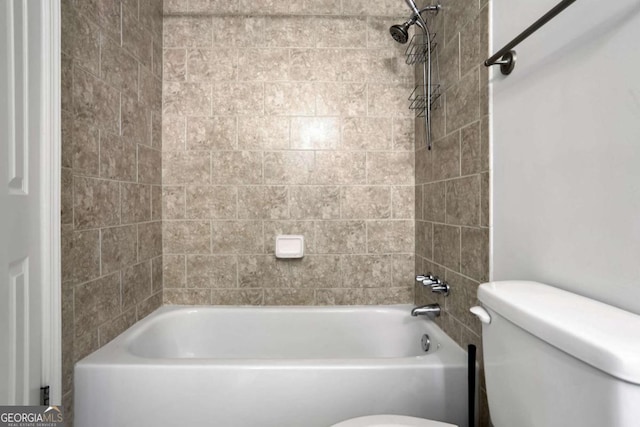 bathroom featuring toilet and tiled shower / bath combo