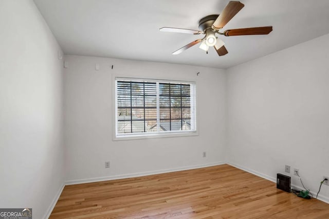 empty room with light wood-type flooring and ceiling fan