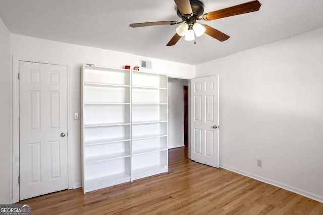 unfurnished bedroom with ceiling fan and light hardwood / wood-style flooring