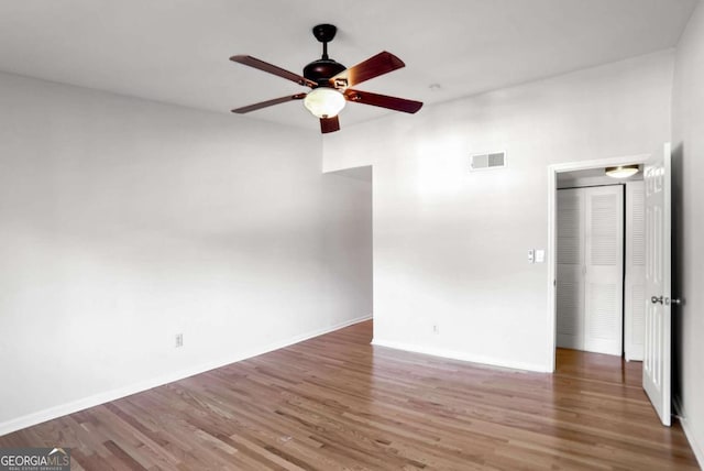 spare room with ceiling fan and dark hardwood / wood-style floors