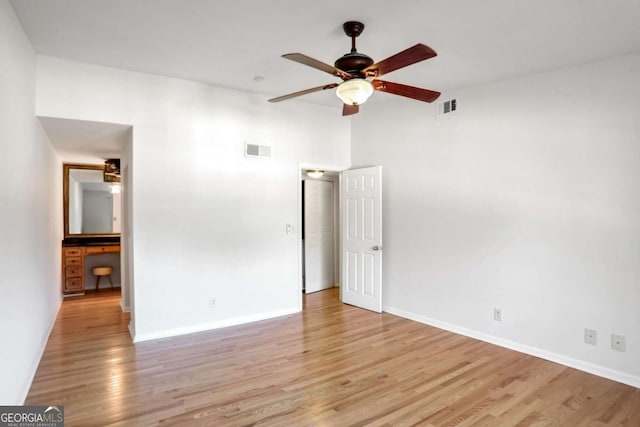 empty room featuring ceiling fan and light hardwood / wood-style flooring