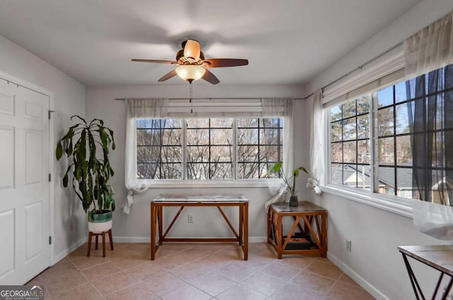 living area featuring ceiling fan and light tile patterned floors