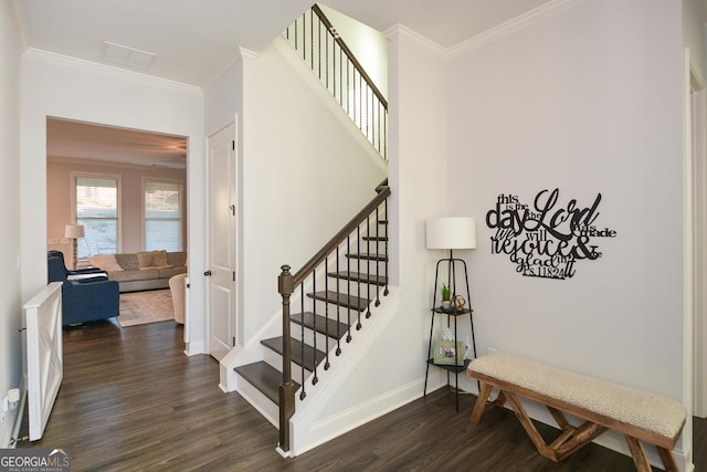 staircase with ornamental molding and wood-type flooring